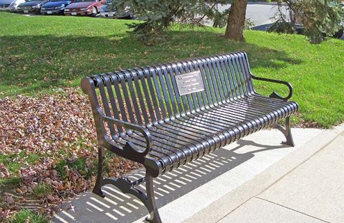 metal bench with plaque