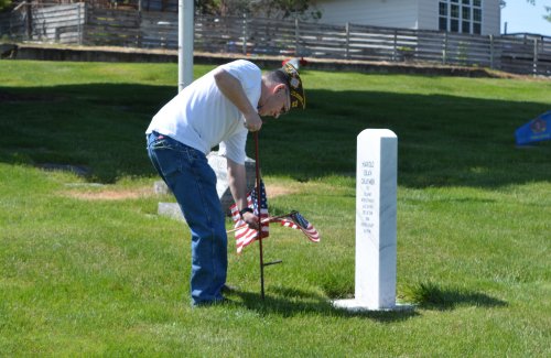 veteran placing flag