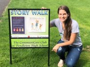 Library Director at Community Park with Story Walk Sign
