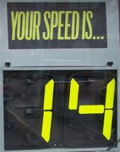 Portable speed radar display that reads, "Your speed is...14"