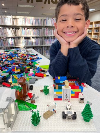 kid smiling over legos